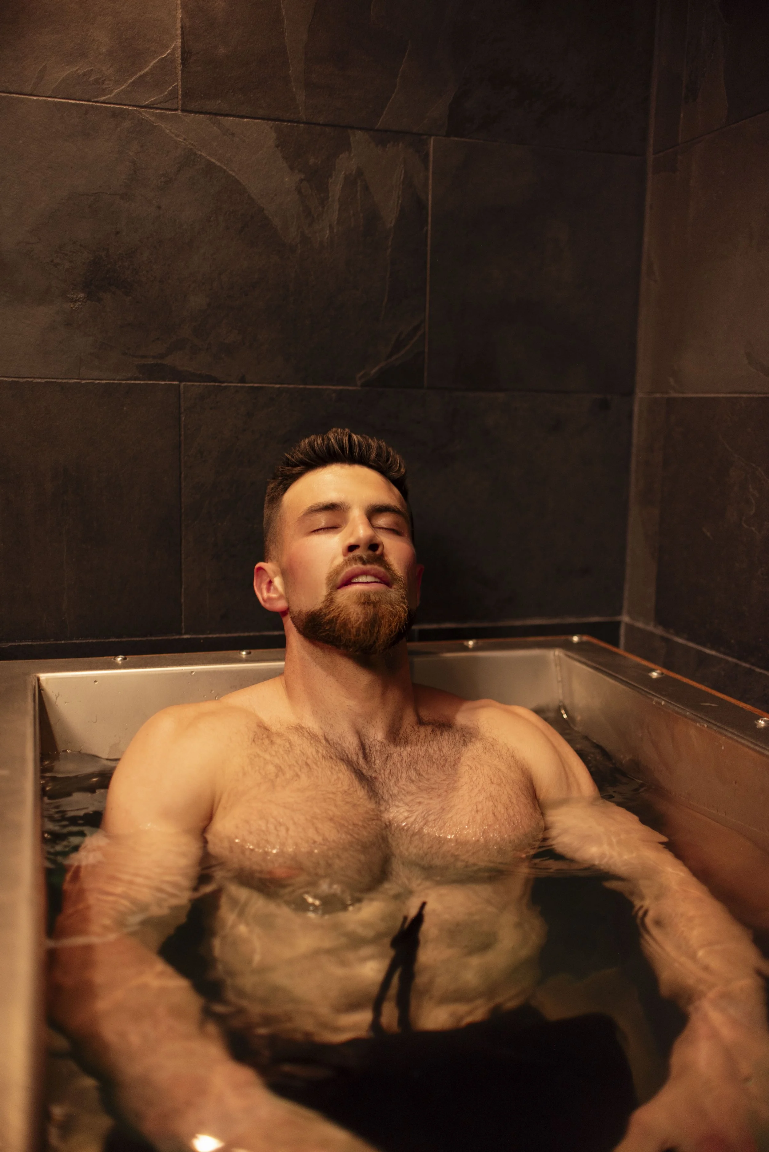 Man in cold plunge at Pure Sweat Studios