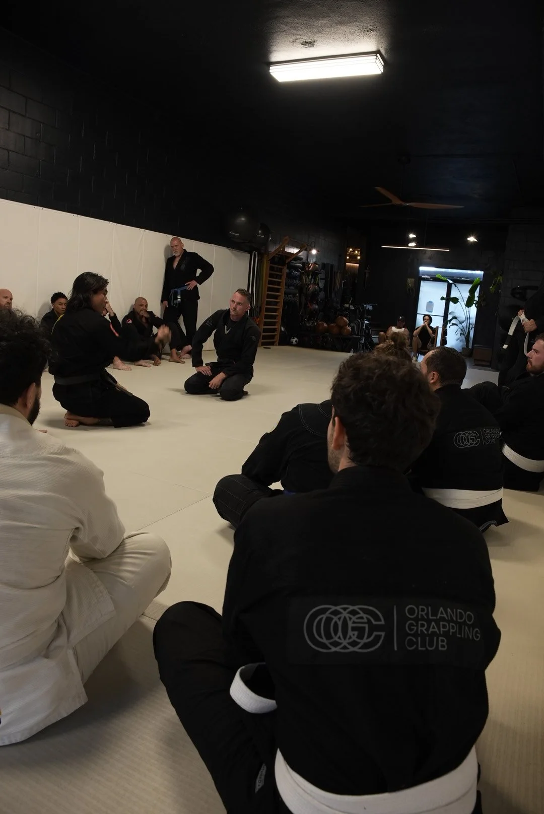 members watching instruction on the mat