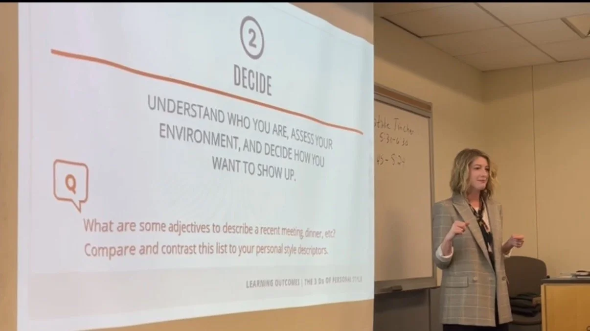 Natalie stands before a presentation slide