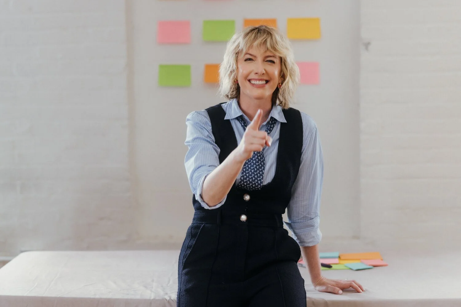 Natalie poses before a wall of sticky notes
