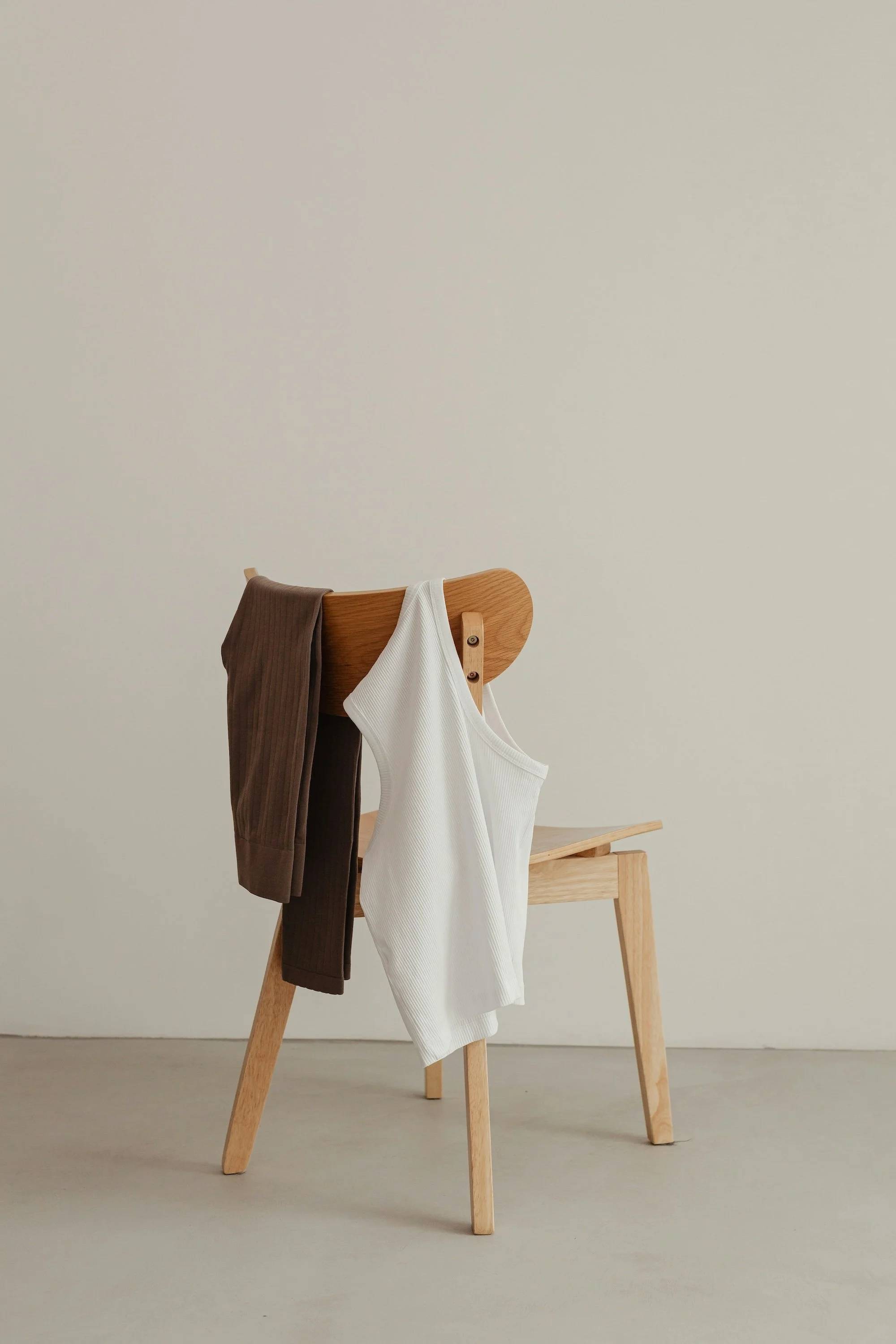 Shirts hung over a wooden chair