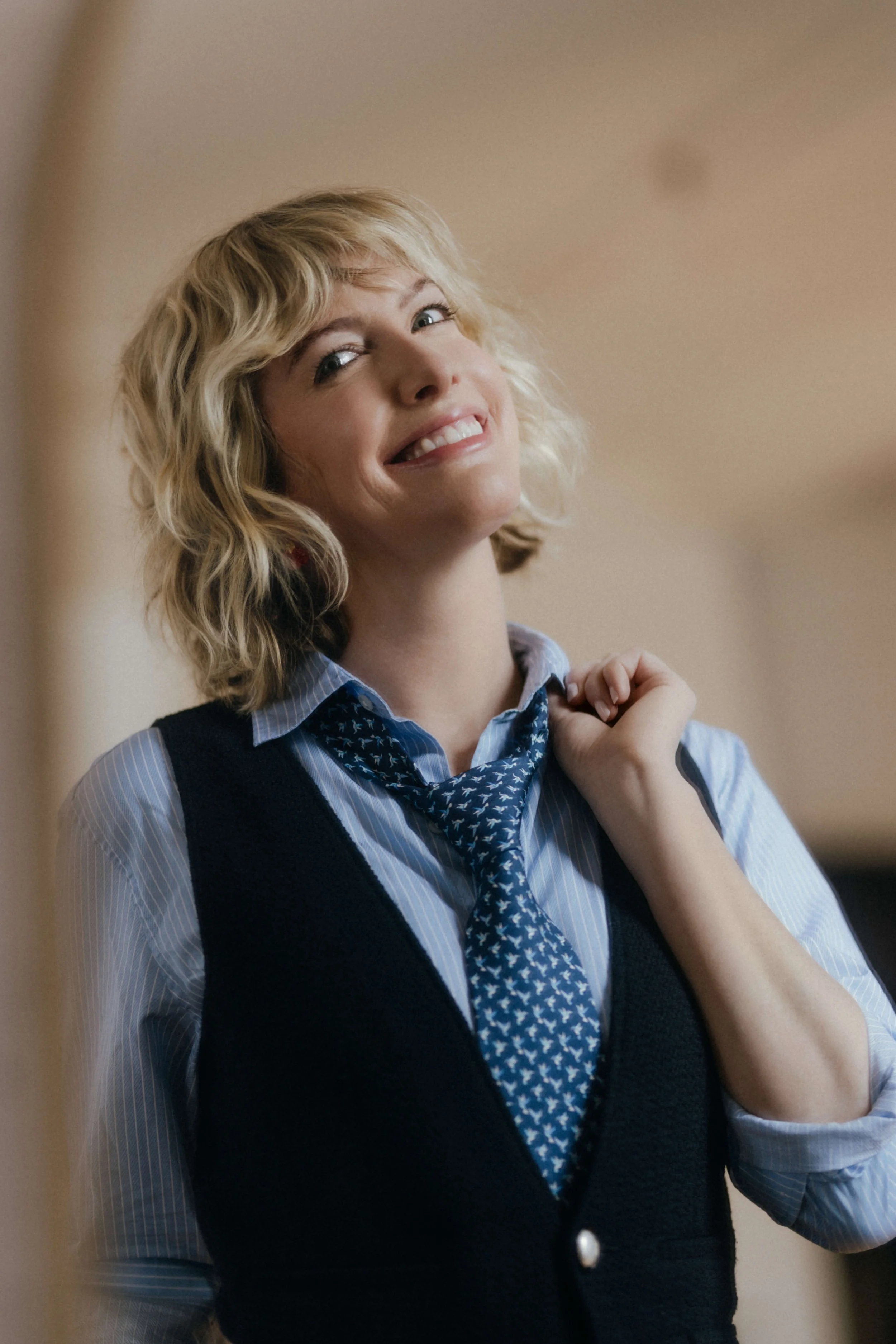 Natalie smiles in a blue suit