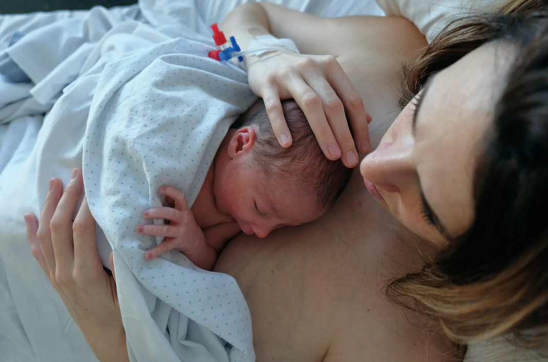 Newborn baby skin to skin on mothers chest