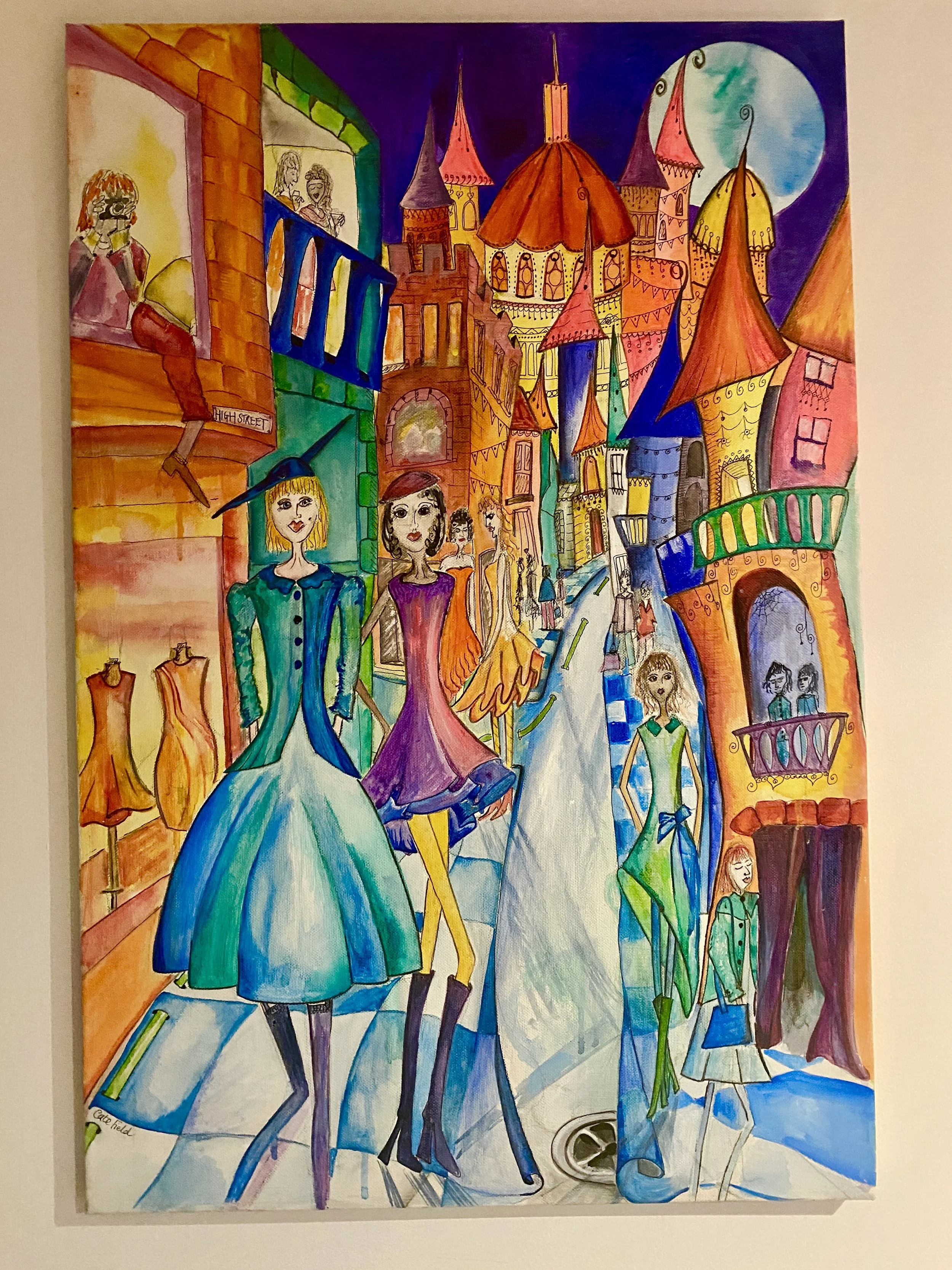 A quirky painting in bright colours featuring a fantasy high street with colourful characters in gorgeous dresses