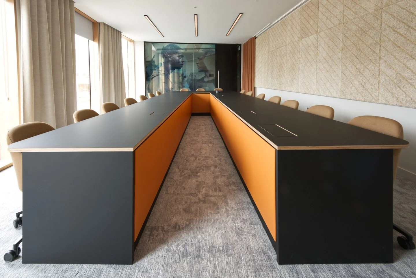 From the archives | Striking a balance between form and function at Netflix 🎬 2022.

This expansive U-shaped boardroom features high-performance Fenix tops finished with an oiled ply edge. We paired the sleek surfaces with bright 3form orange full-h