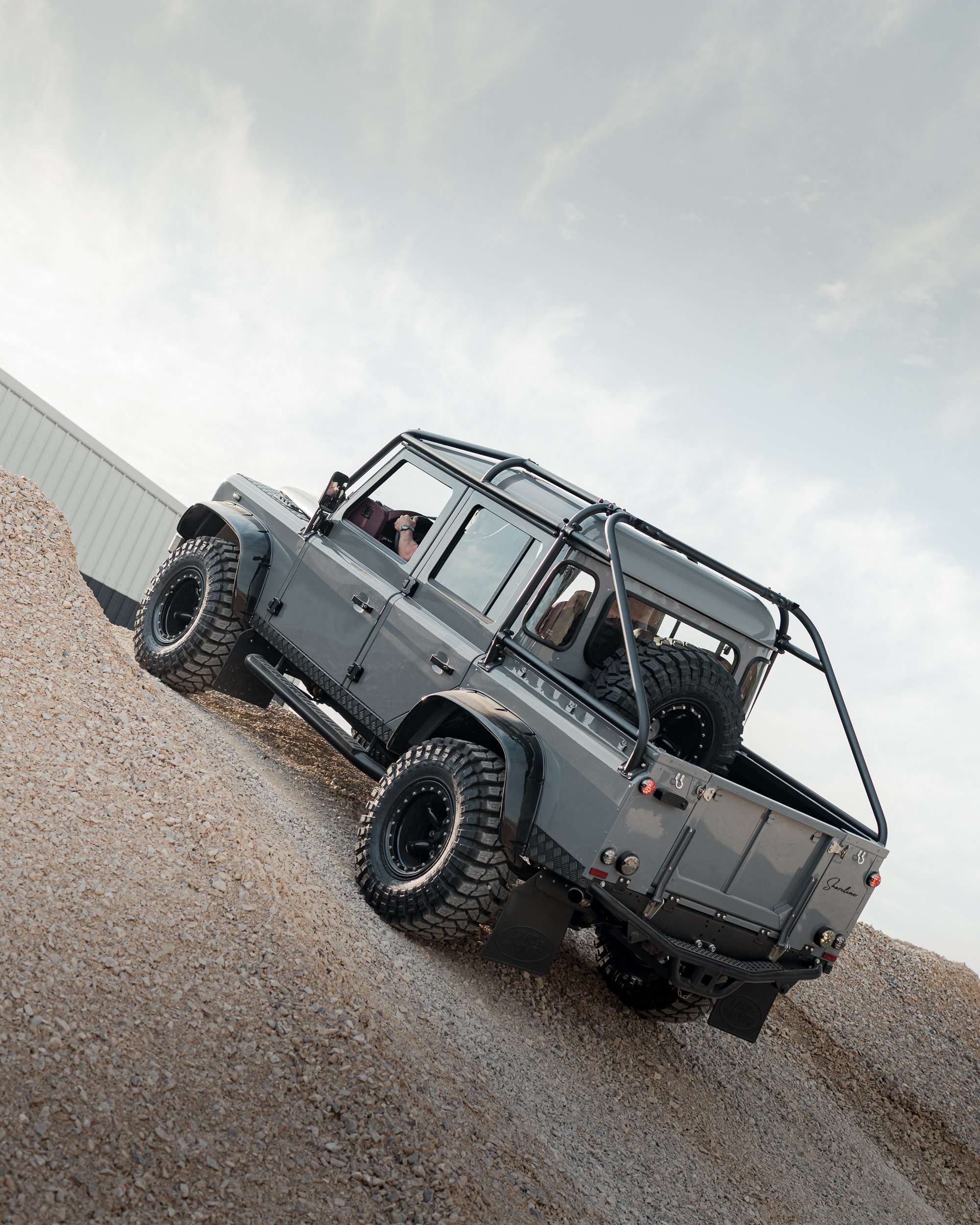 Shoreline Defender 110 Double Cab Spectre build in Nardo Grey climbing rocks