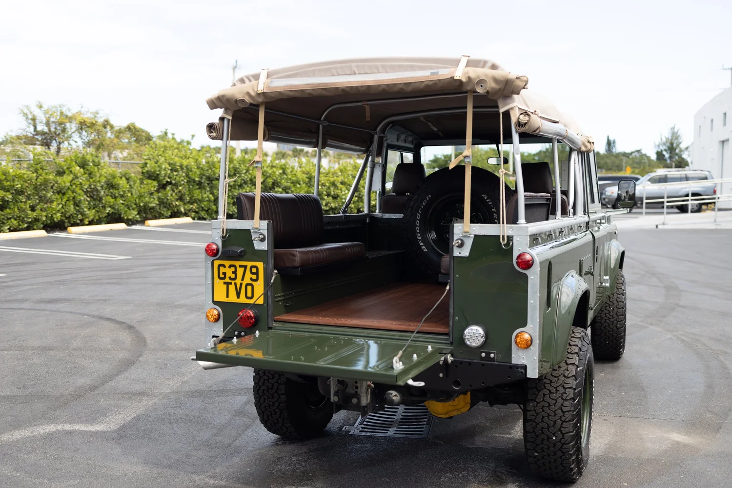 Marine-grade teak wood flooring in the rear of a restored Defender 110 Soft Top