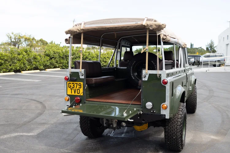 Marine-grade teak wood flooring in the rear of a restored Defender 110 Soft Top