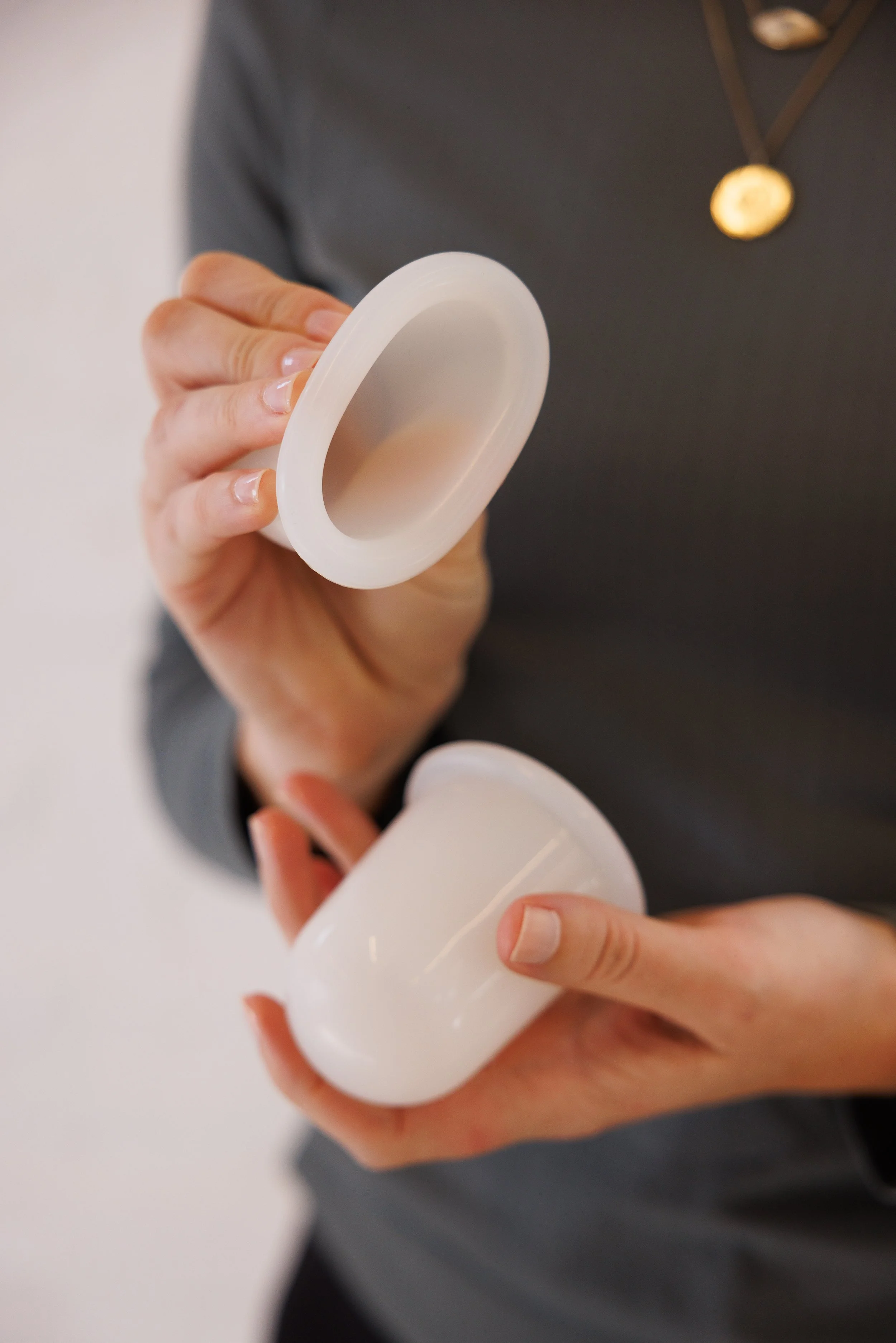 Dr. Sandy Arthur holding cupping devices in hands, used in her office in Sarasota, FL