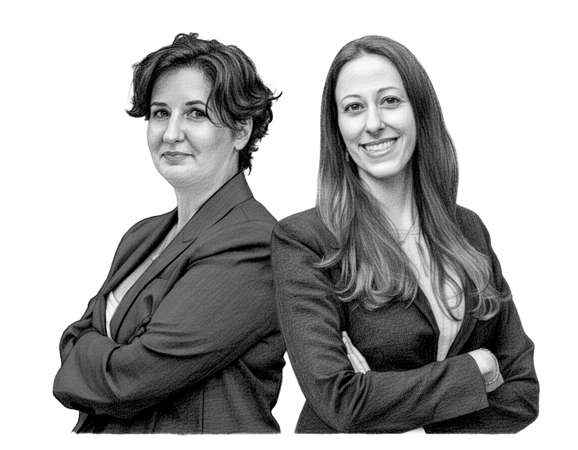 Two women standing side by side with crossed arms, smiling, dressed in business suits, in black and white.