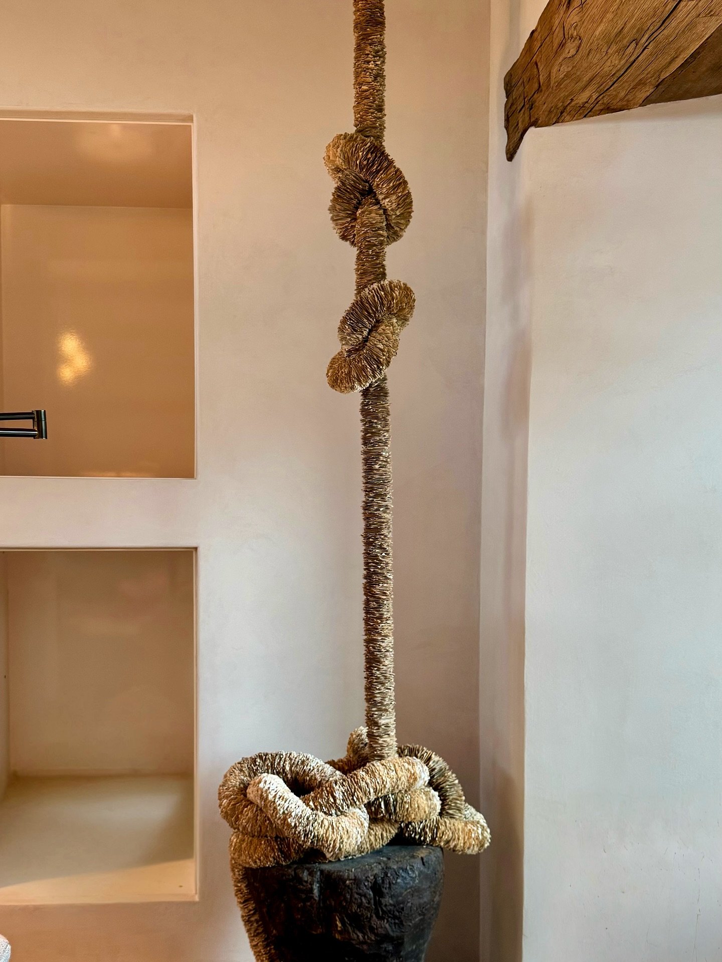 Tethered Romance 

Composed of hand-cut 2&rdquo; x 2&rdquo; paper squares, each individually threaded onto cable, the work spans 33 feet across three separate 11-foot sections. Its scale is striking, but its true character lies in its flexibility: th