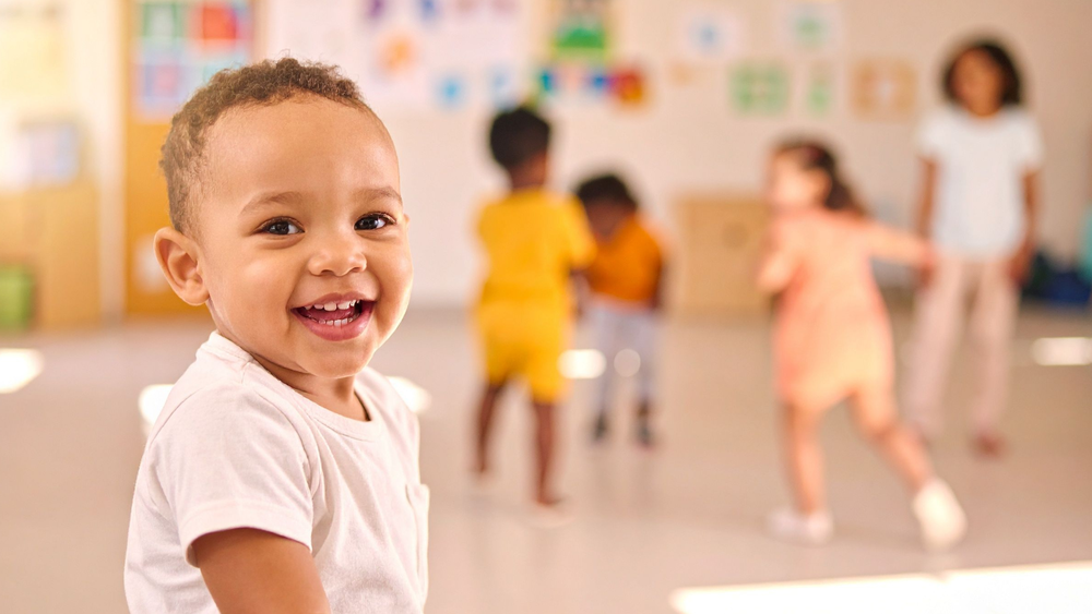 Happy baby in a safe and nurturing daycare classroom at Christ Little Rock School.