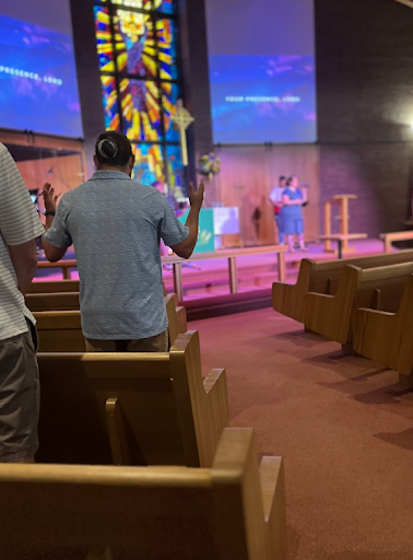 Parents worshiping during a chapel service at Christ Little Rock School, highlighting faith-centered education and community life.