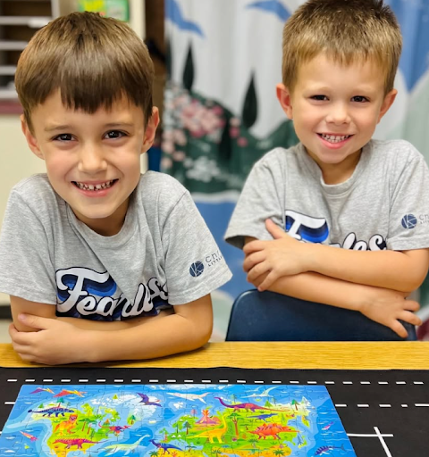Two elementary students smiling during classroom learning at Christ Little Rock School, a Christian school in Little Rock.