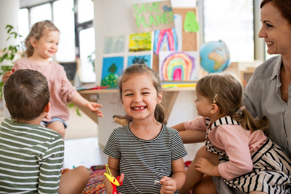 a child smiling happily while in preschool showing she is ready to learn and socialize with others