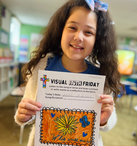 Elementary student holding artwork from a classroom project at Christ Little Rock School, a Christian school in Little Rock.