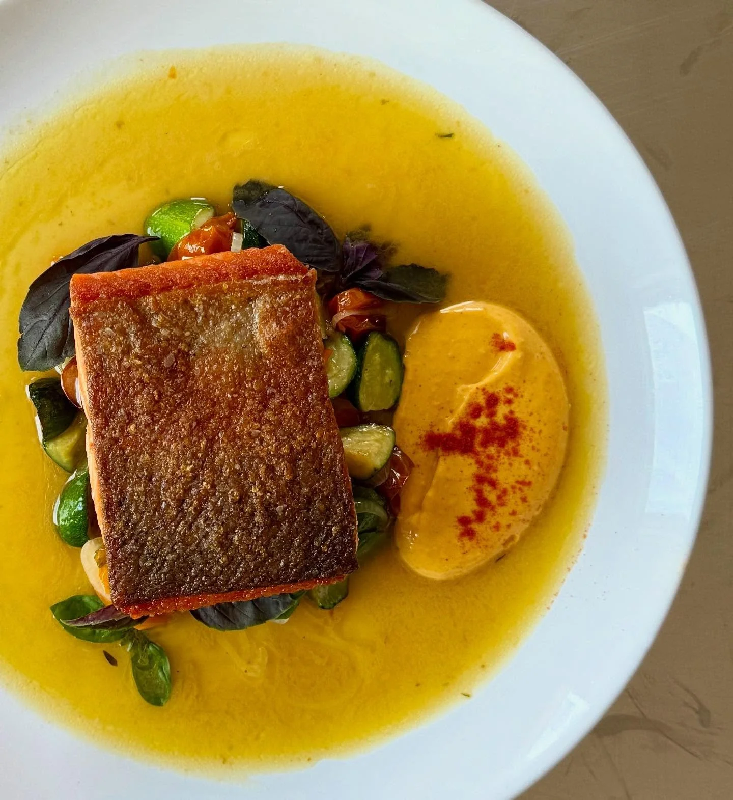 New Hampshire Steelhead Trout, roast sungold tomatoes, zucchini, shallot, rouille, basil. 
Rouille is a traditional French sauce originating from the Provence region, often served with seafood dishes like bouillabaisse or, in this case, your New Hamp