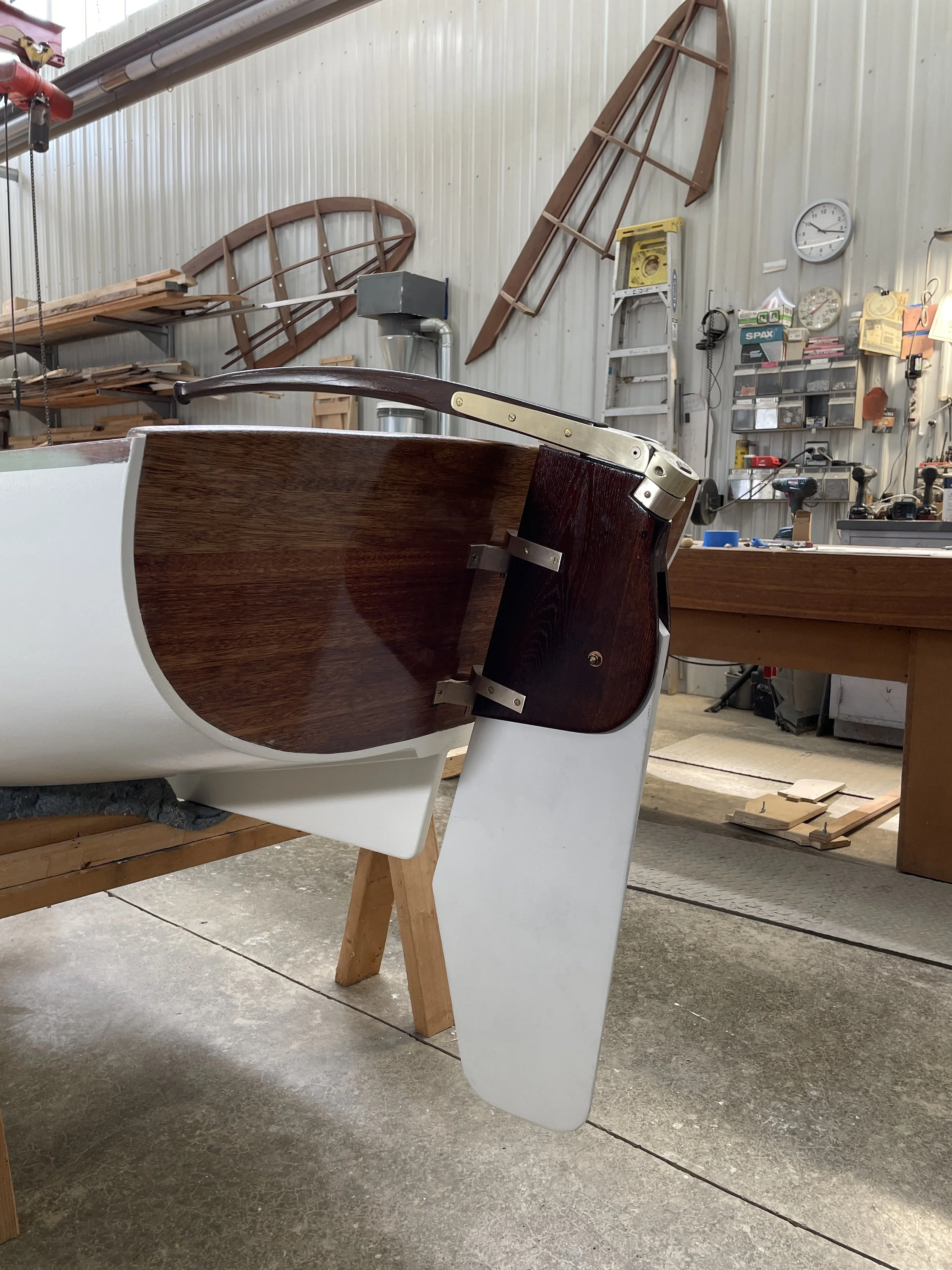 image of the rudder and tiller of a wooden dinghy.