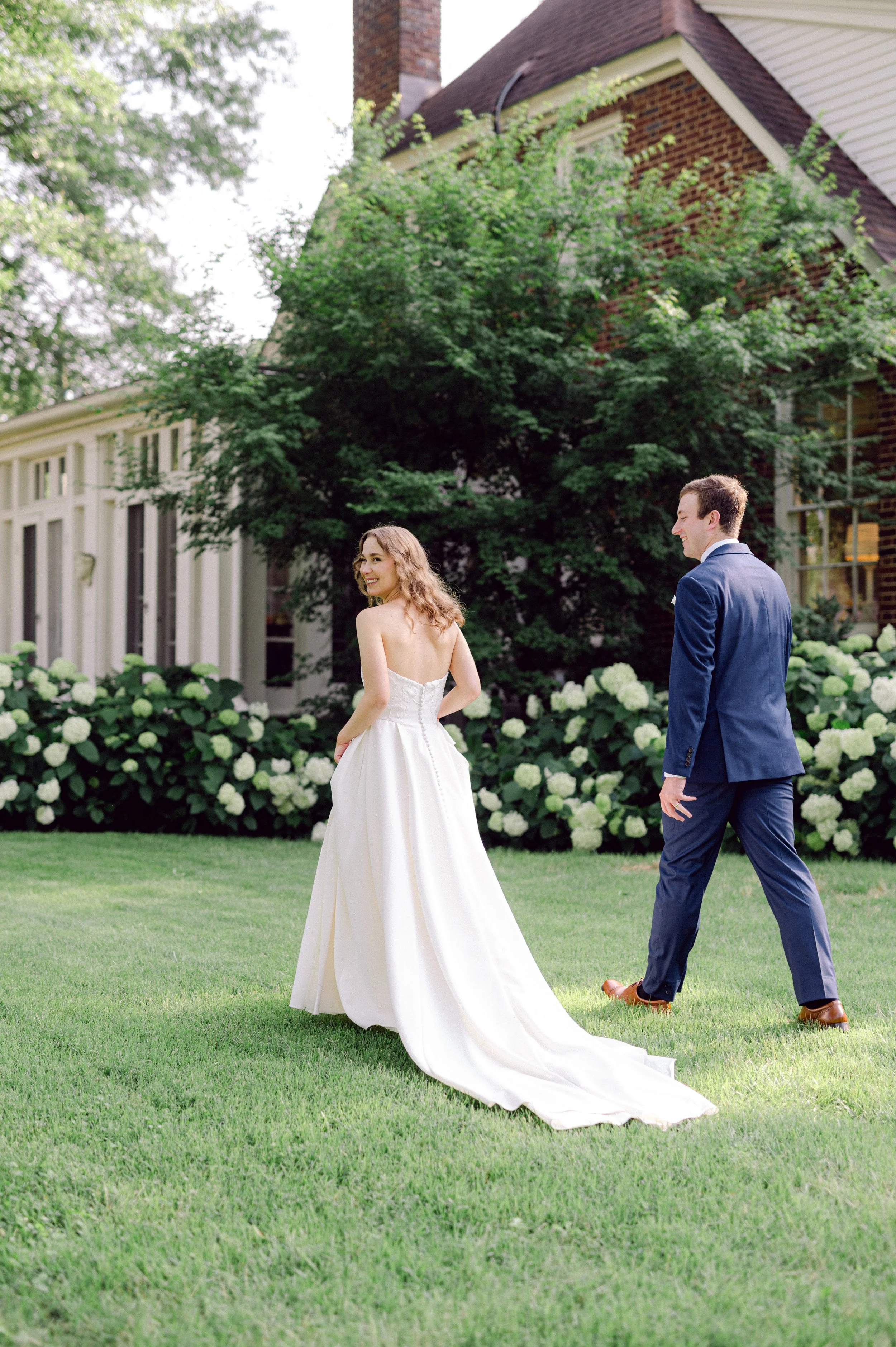 bride & groom walking through private gardens