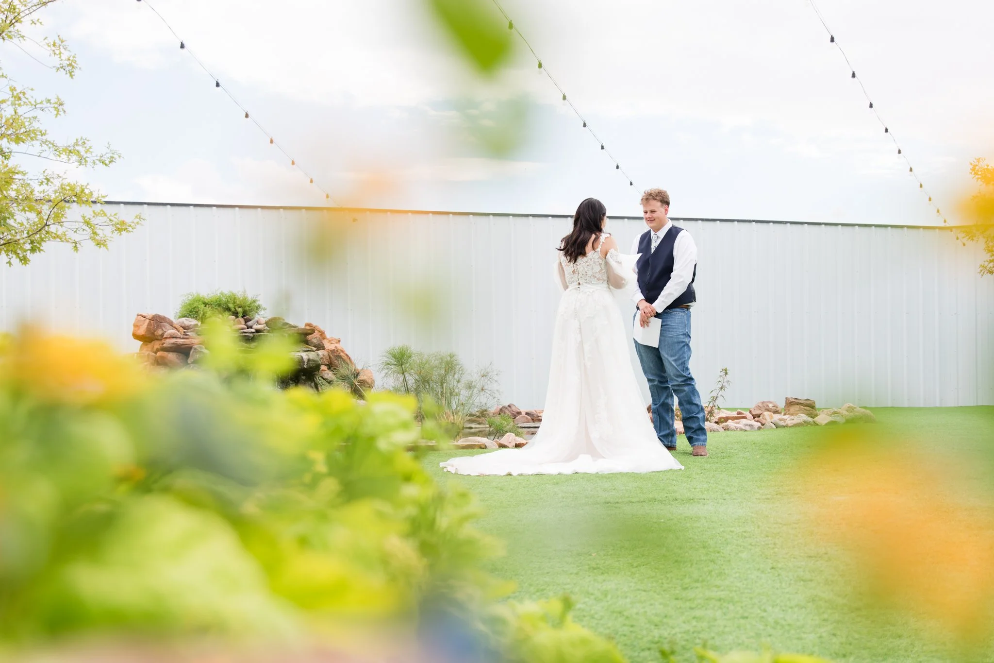 A green serene atmosphere with a bride and groom sharing private vows.