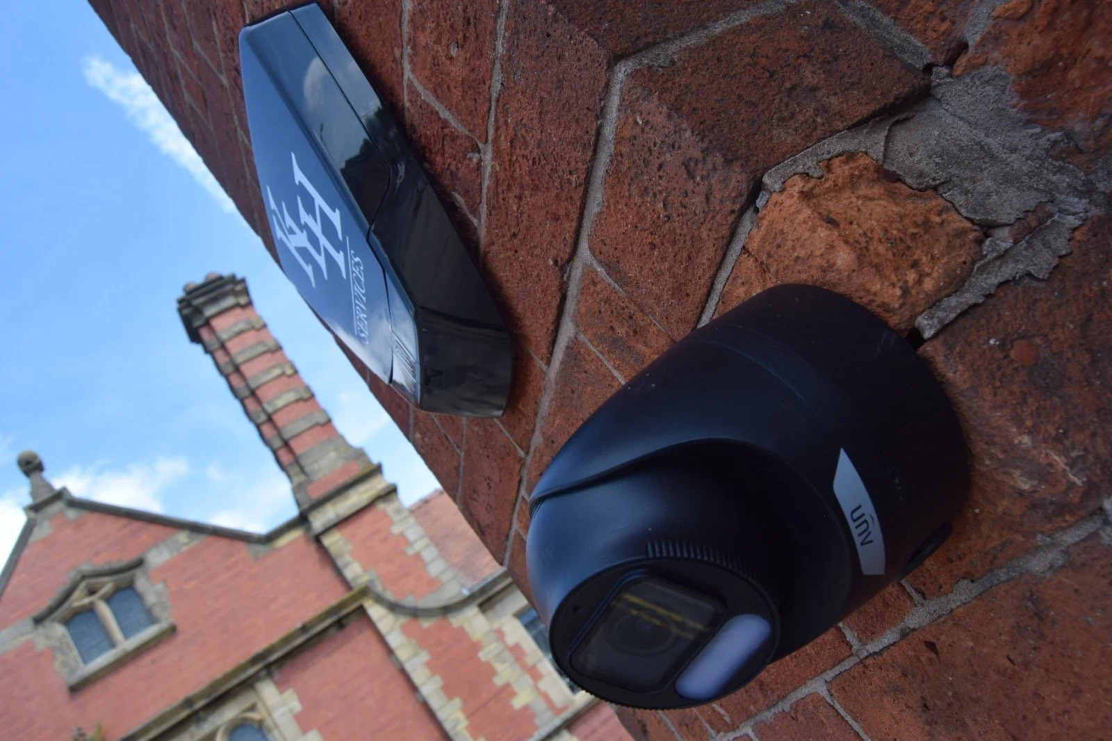 CCTV camera installed on brick building for 24/7 security in North West.