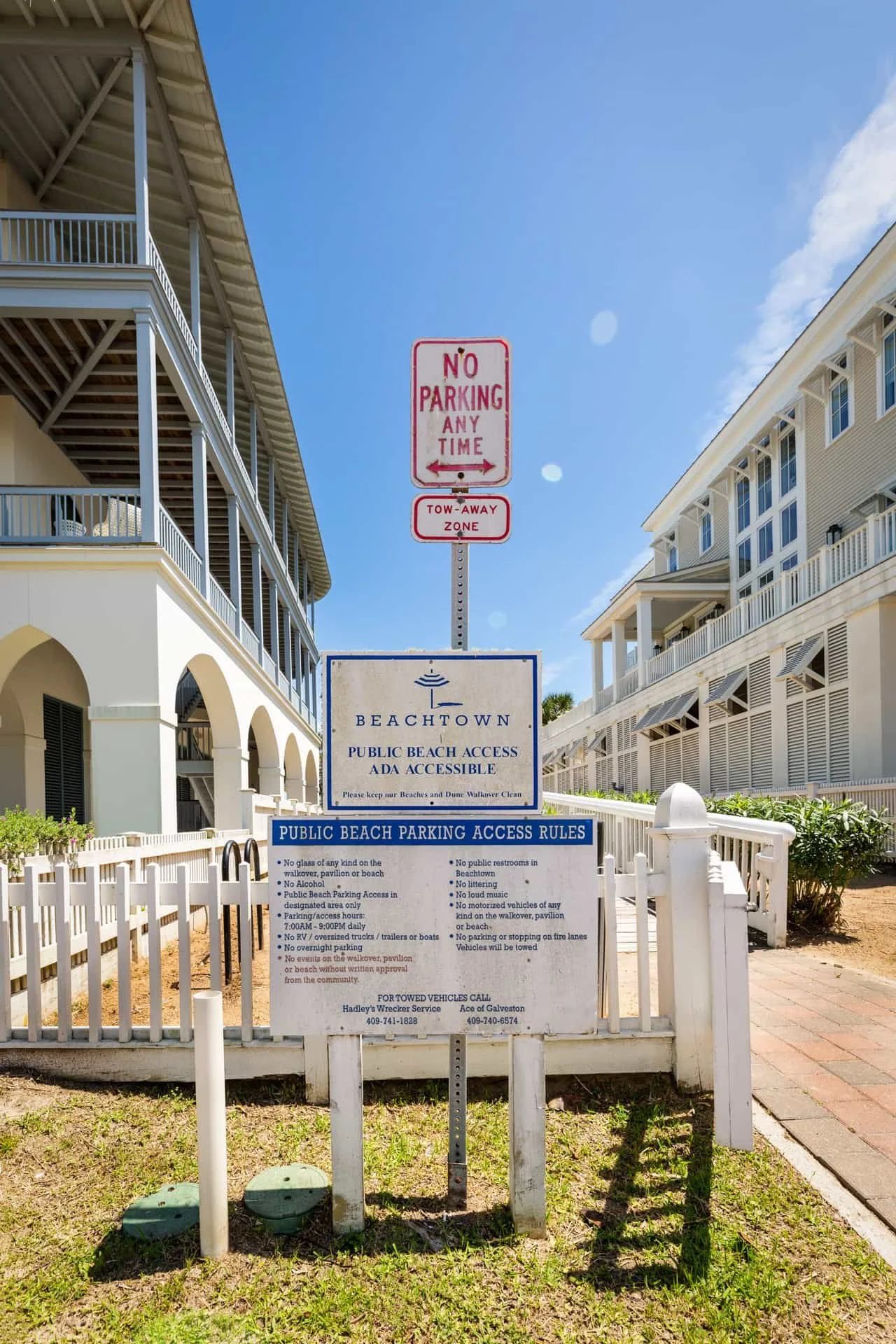 Signs at Beachtown indicating public beach access and parking rules, including no parking, tow-away zone, and prohibited activities.