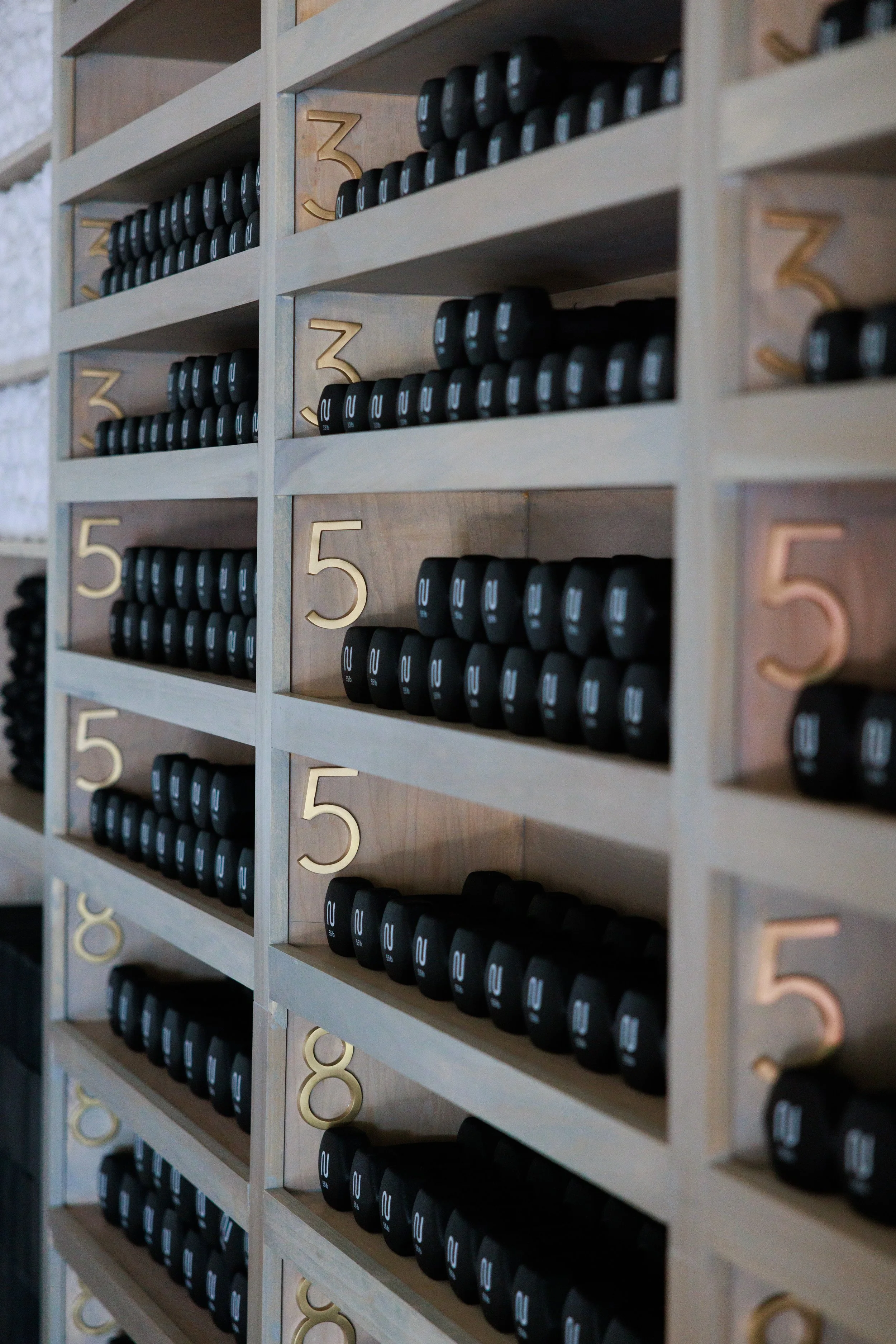 Interior photography shot showcasing shelves with weights at Nooma studio in Dallas.