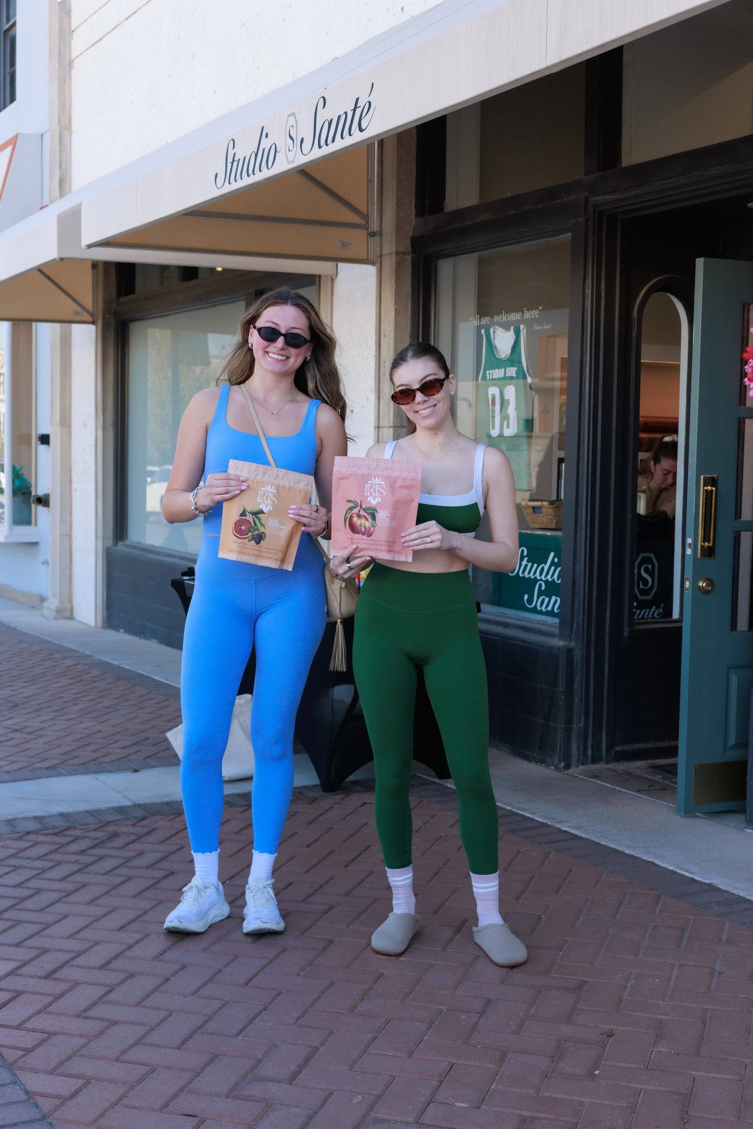 Two SMU students posing with a CPG brand at a storefront retail activation in Snider Plaza Dallas.