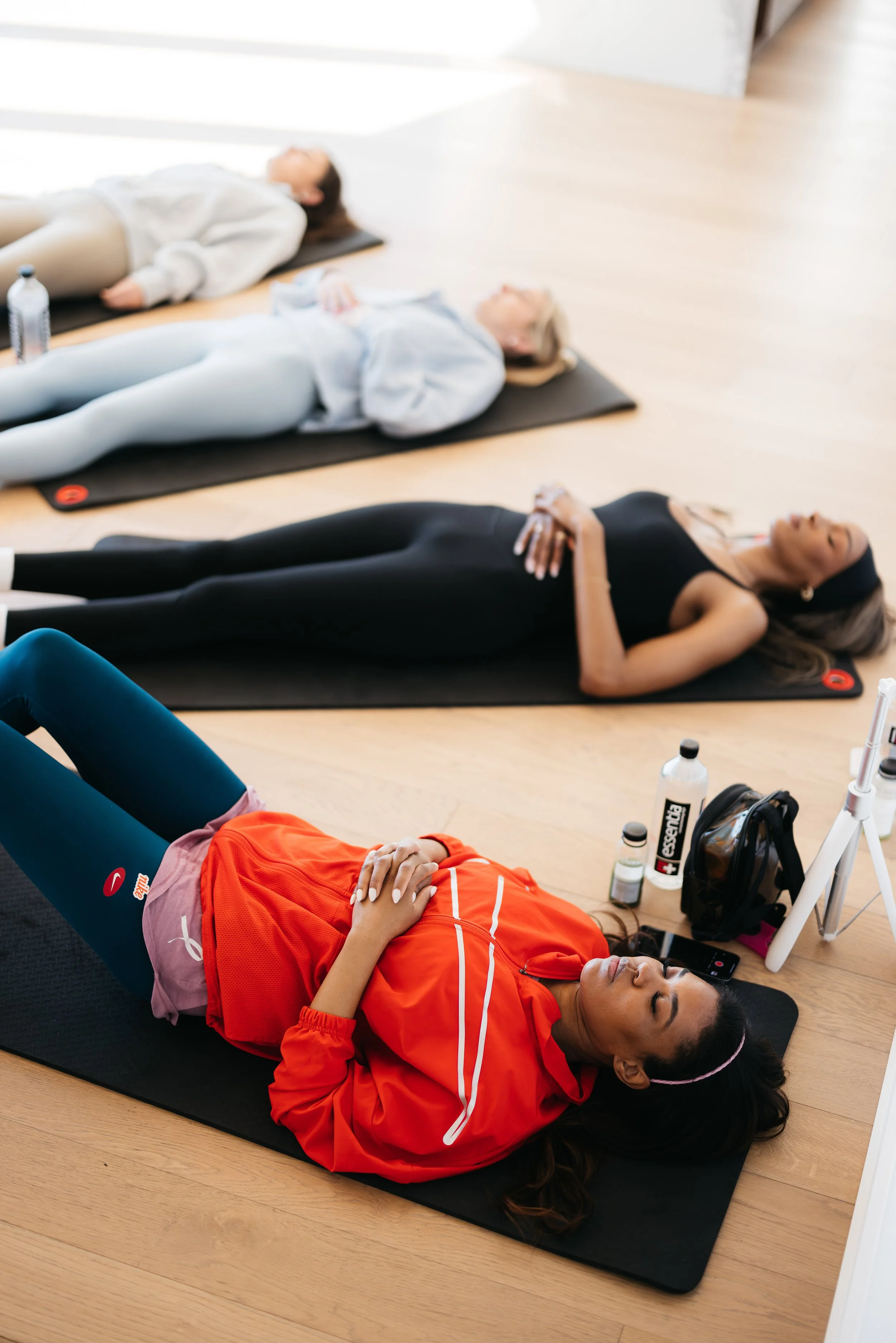 Dallas influencers meditating on yoga mats at AMLI Fountain Place brand experience event.