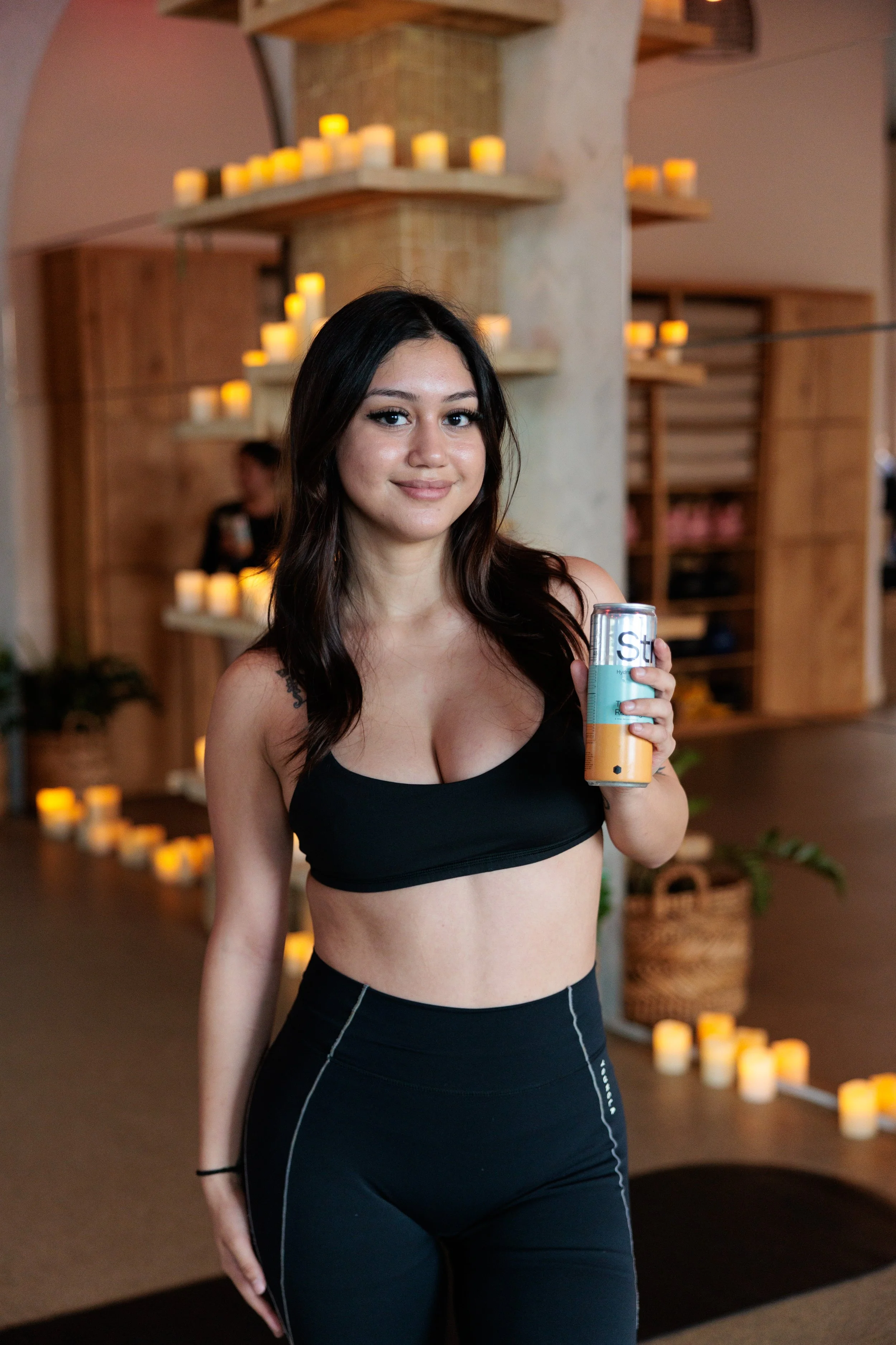 Local Dallas creator posing with a can of Strive Soda at a brand Jungle studio activation event.