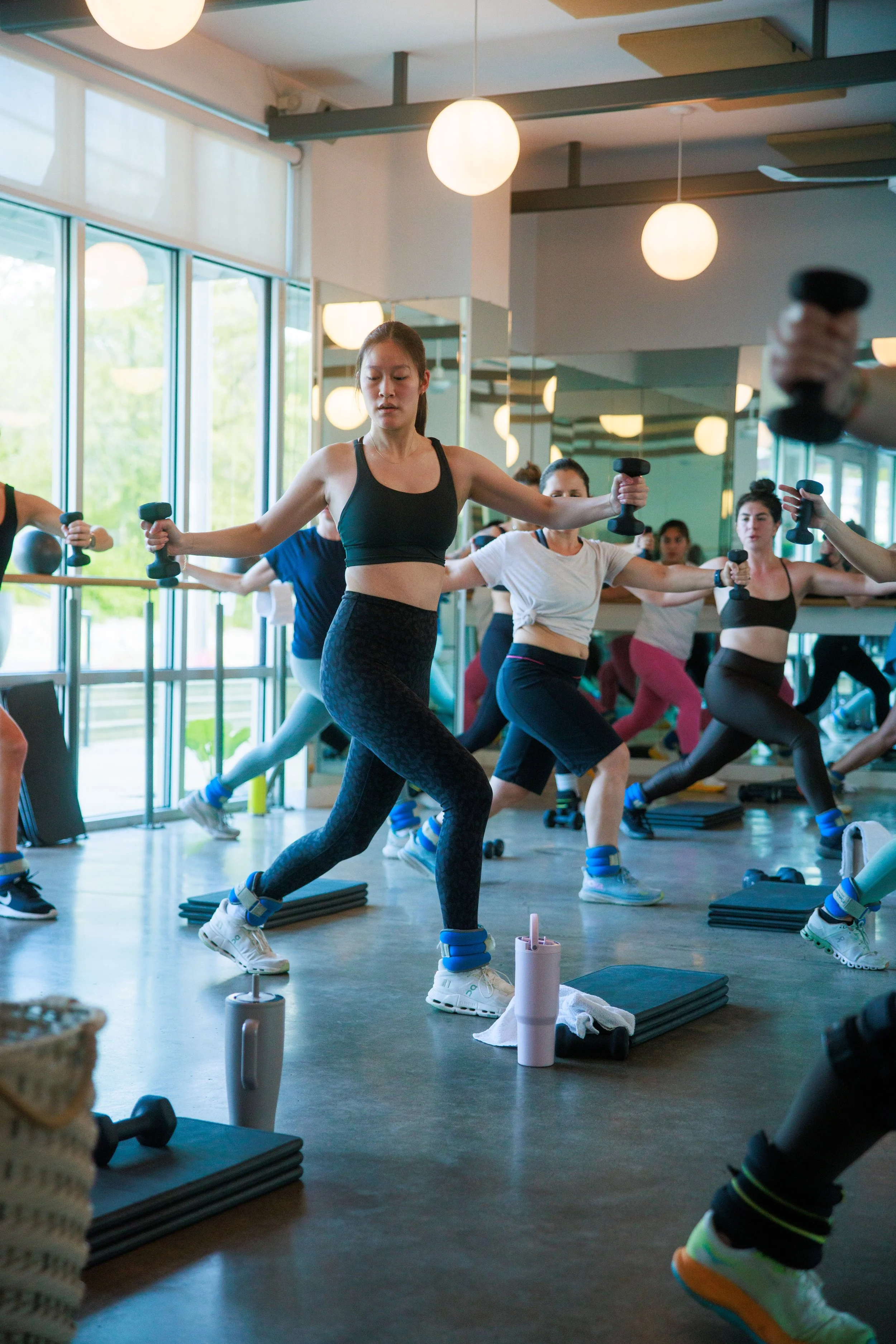Fitness studio members exercising in a class.
