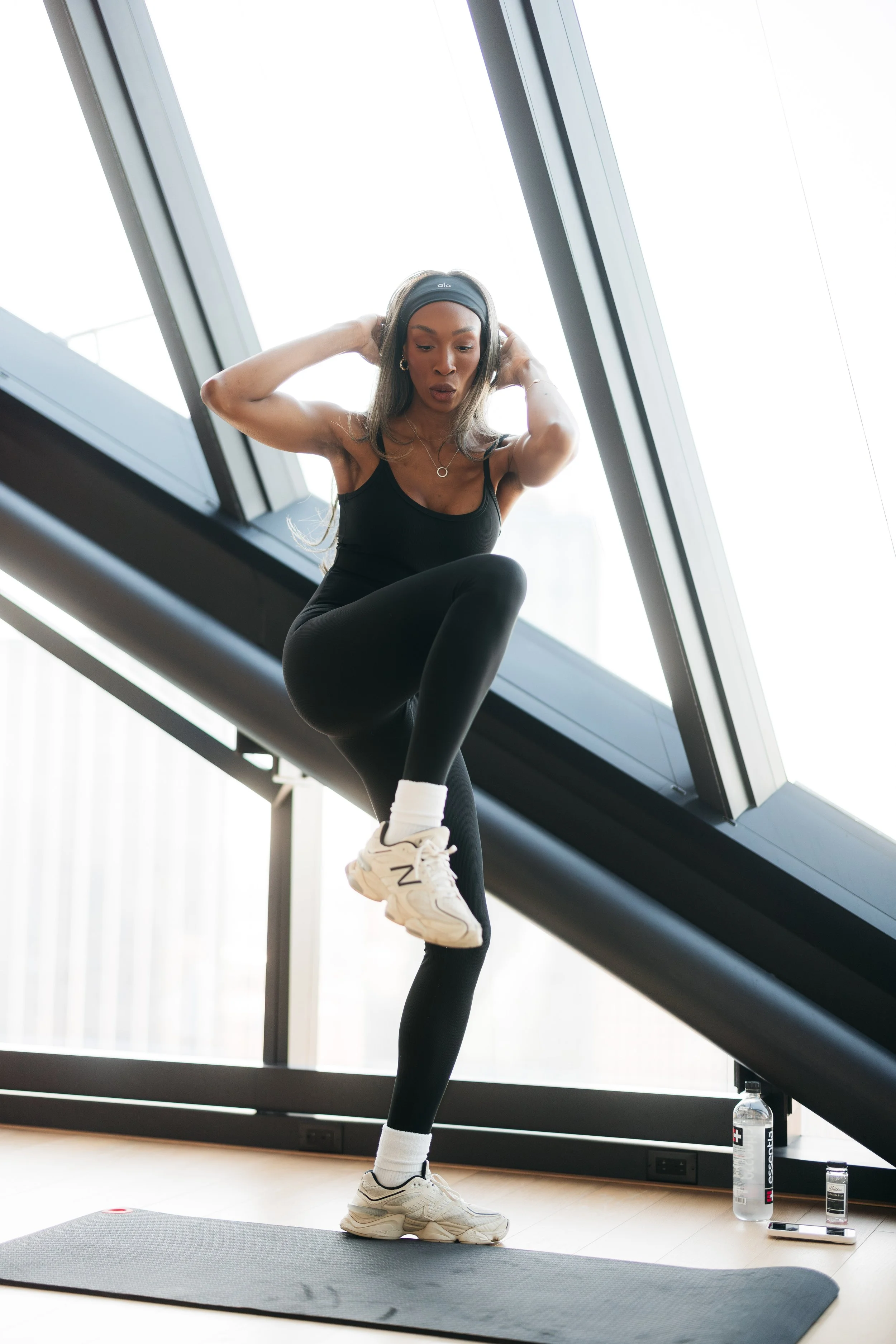 Influencer performing an exercise at AMLI Fountain Place brand activation event.