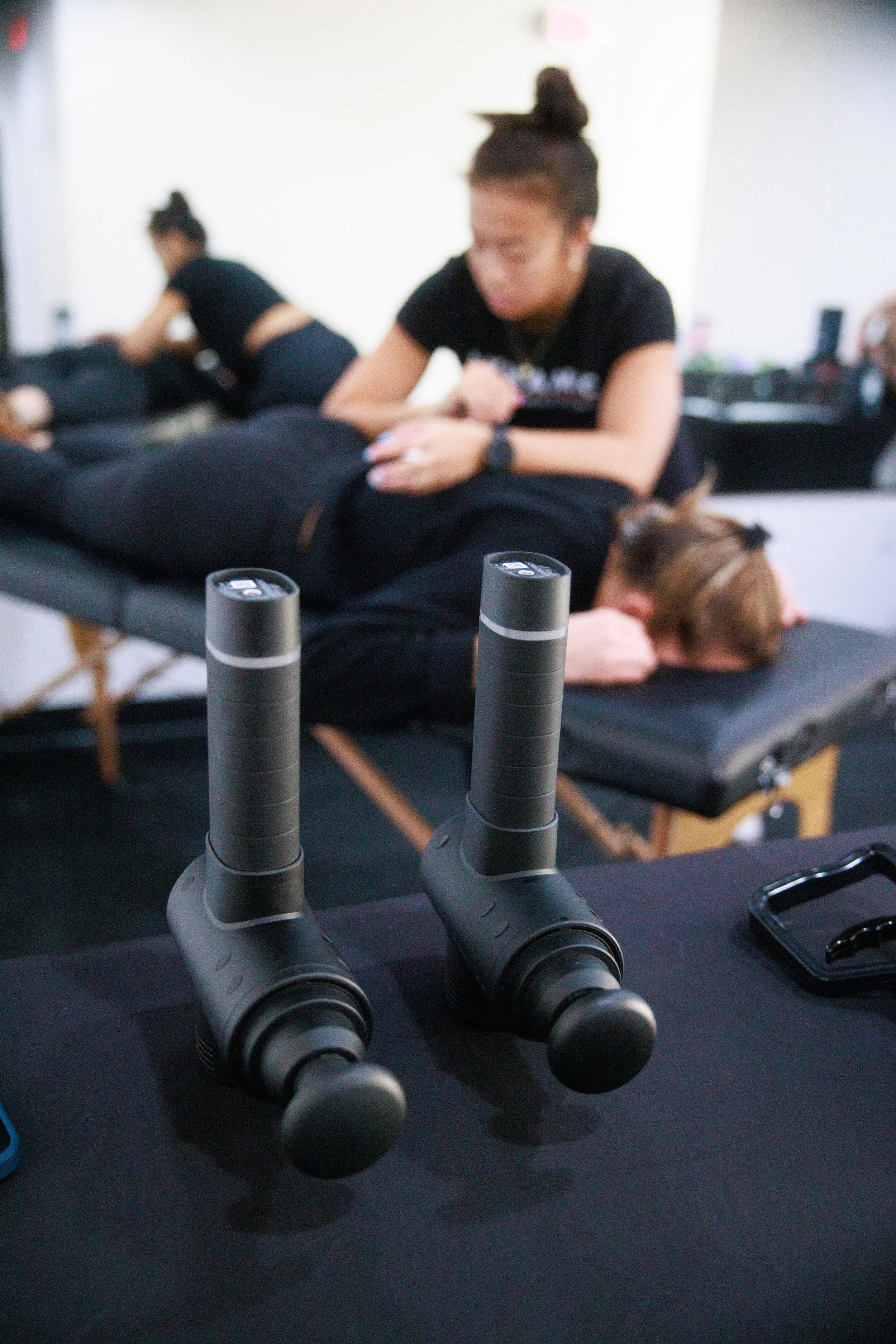 Detailed shot of a chiropractor performing a treatment at brand collaboration event in a fitness studio.