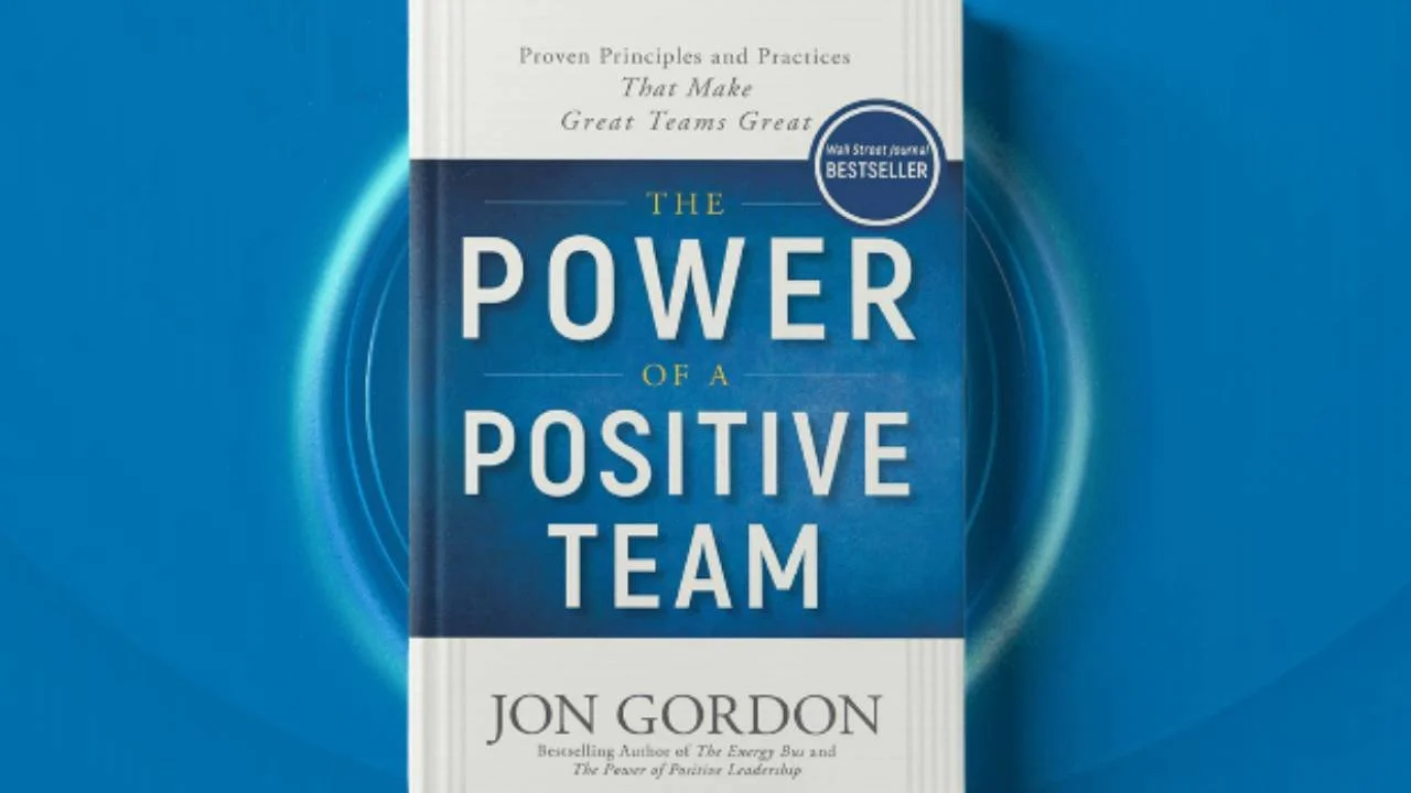 Cover of the book 'The Power of a Positive Team' by Jon Gordon, featuring blue and white design with text highlights about team principles. Wall Street Journal Bestseller sticker present.