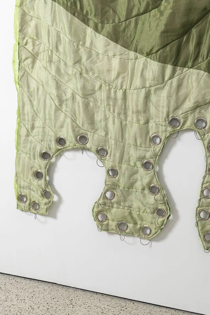 Pierced, 2025, fabric, organza, cotton thread, eyelets, cotton stuffing, stainless steel, 190x140x6.5 cm