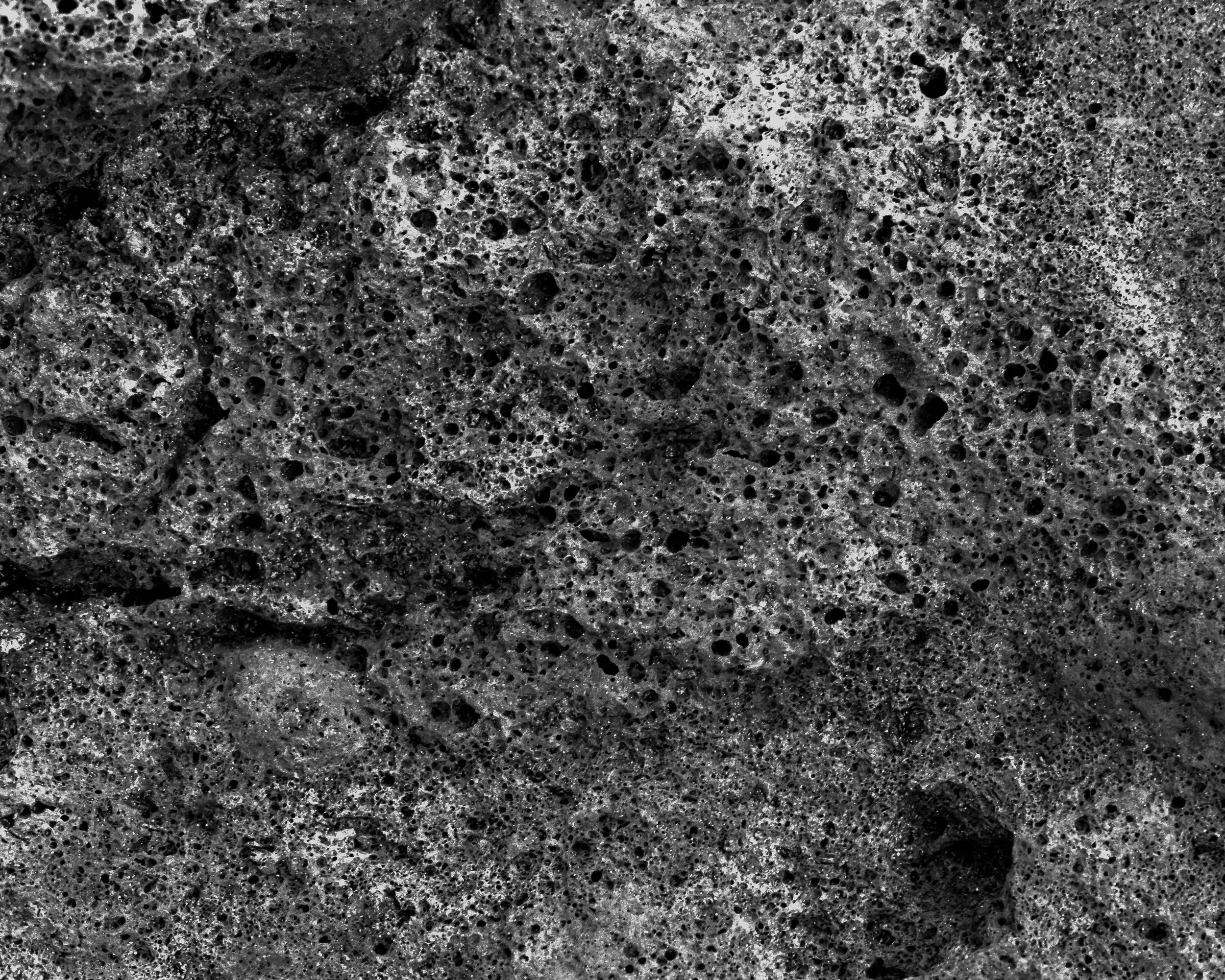 Close-up of dark, porous volcanic rock surface.