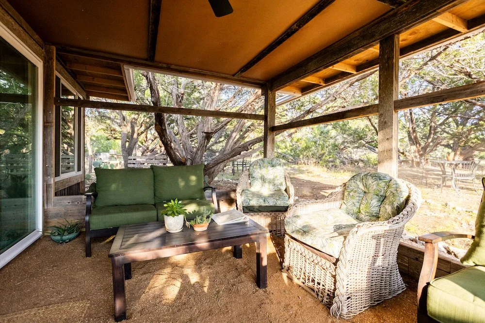 The kitchen has an attached screened sitting porch. 