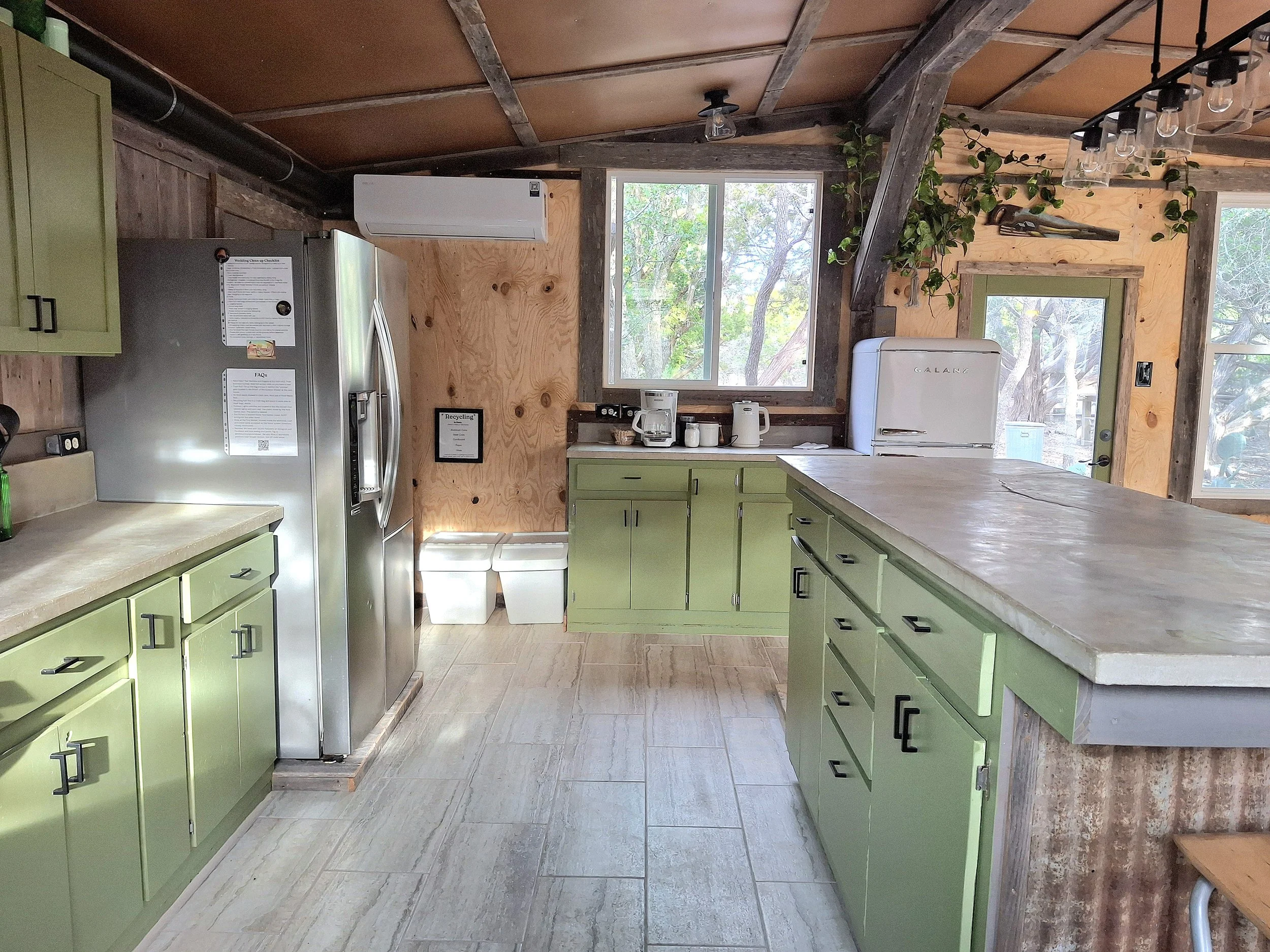 event center kitchen with cream tiled floor and green cabinets