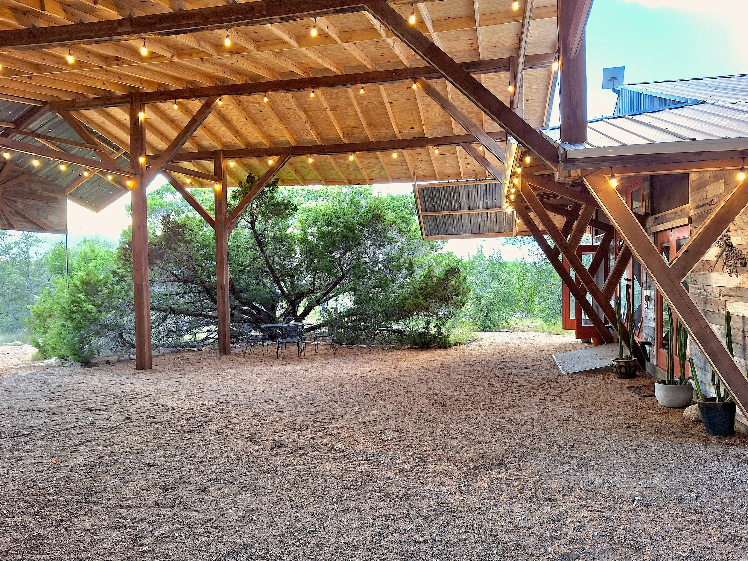 The Courtyard: located directly outside of the workshop, this 1400 sq ft covered space is perfect for a reception, dancing, morning yoga or general gathering area. Can seat 64 for dining, using our round tables, and could squeeze more if needed. This