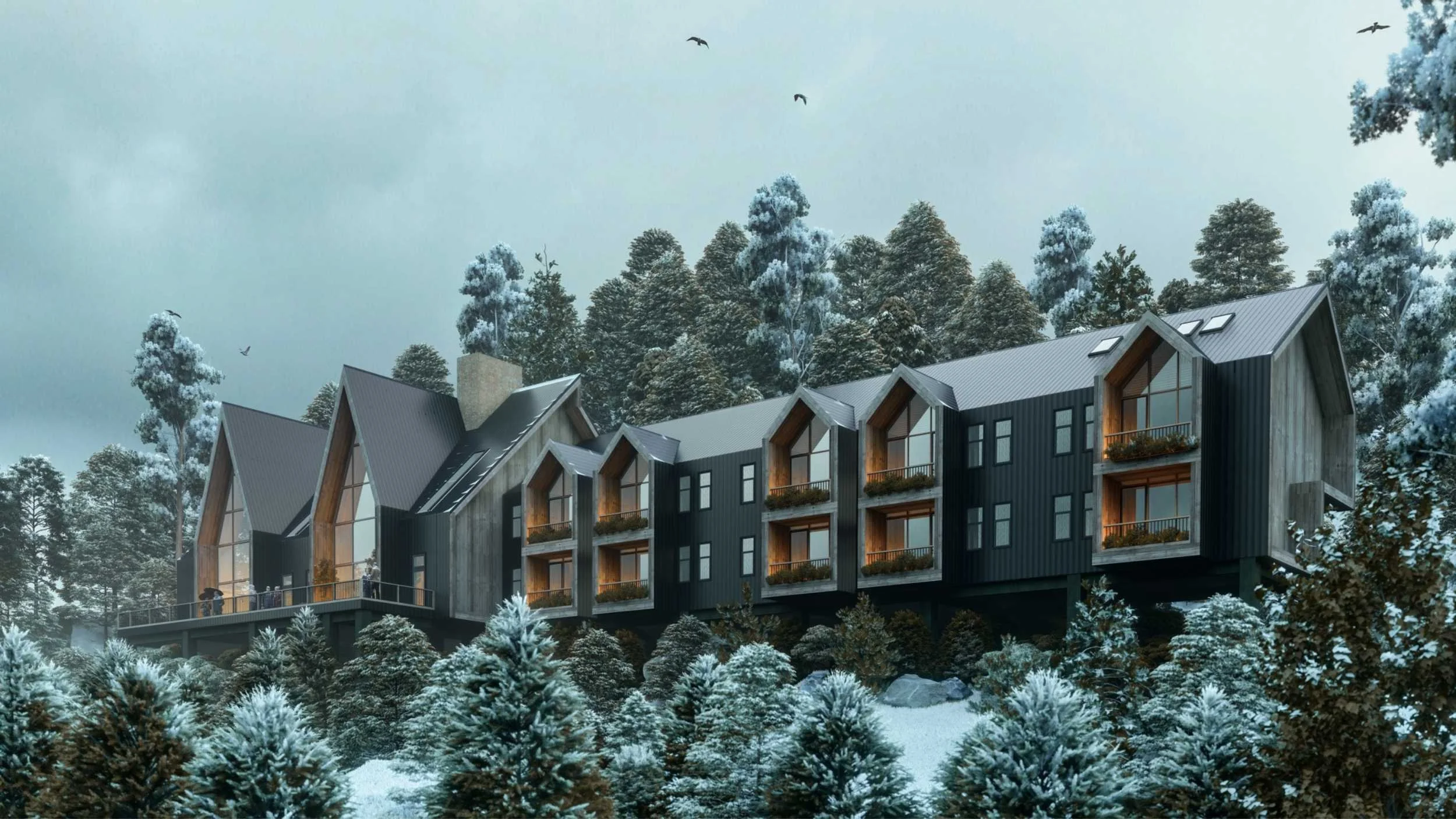 Cabañas modernas en un paisaje nevado rodeado de árboles y montañas.