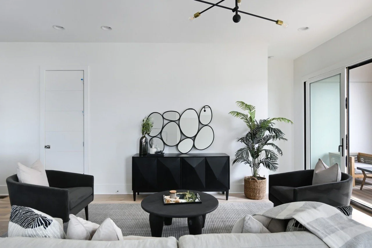 Modern living room with access to a private balcony, featuring contemporary decor in a Chestnut Hill townhouse