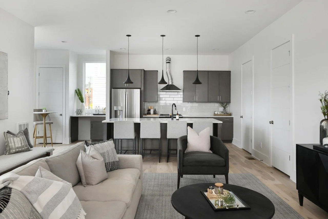 Modern living room with access to a private balcony, featuring contemporary decor in a Chestnut Hill townhouse