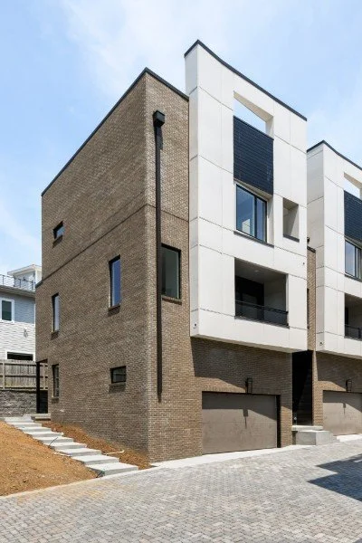 Exterior view of a modern townhouse in Chestnut Hill, Nashville, featuring a private garage and contemporary design.