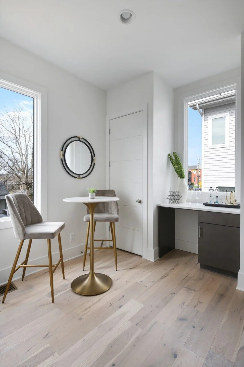 Elegant kitchen island with seating and stylish pendant lights in a modern Chestnut Hill townhouse available for rent