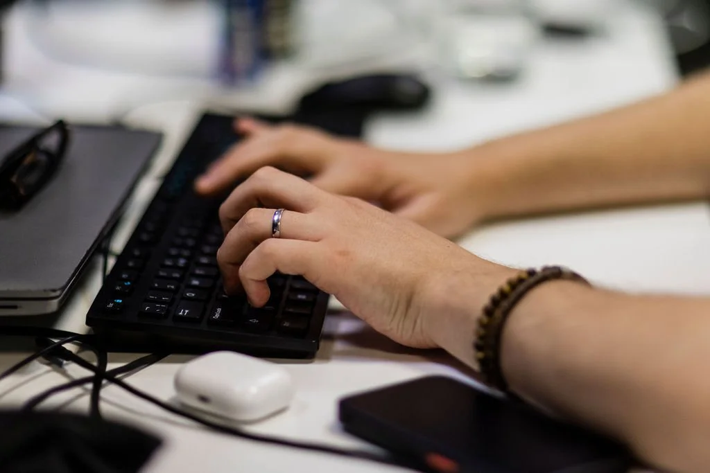 Hands typing on a keyboard