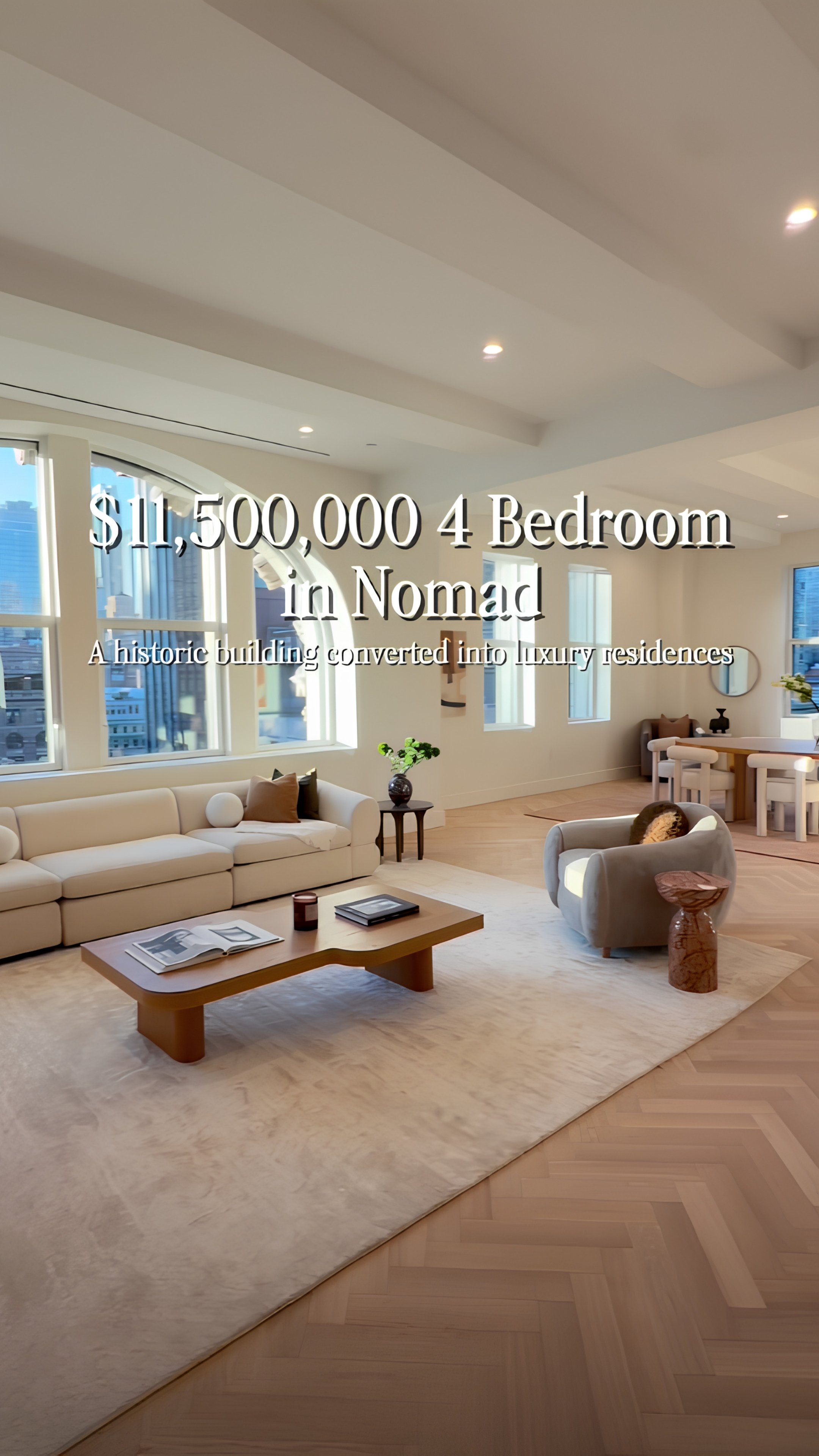 Bright living room with large windows, white sofas, a wooden coffee table, and modern decor.