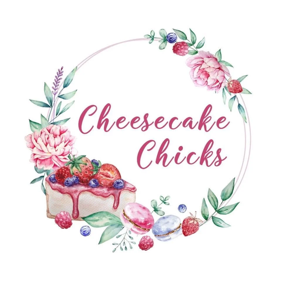 A floral wreath with strawberries, raspberries, blueberries, pink peonies, and macarons surrounds the text "Cheesecake Chicks" in cursive