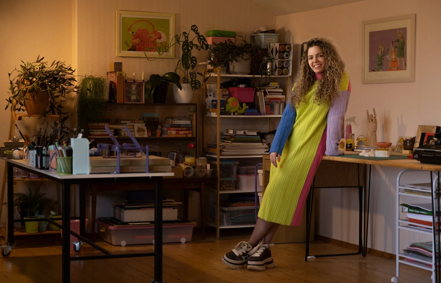 Woman seated in a colorful workspace