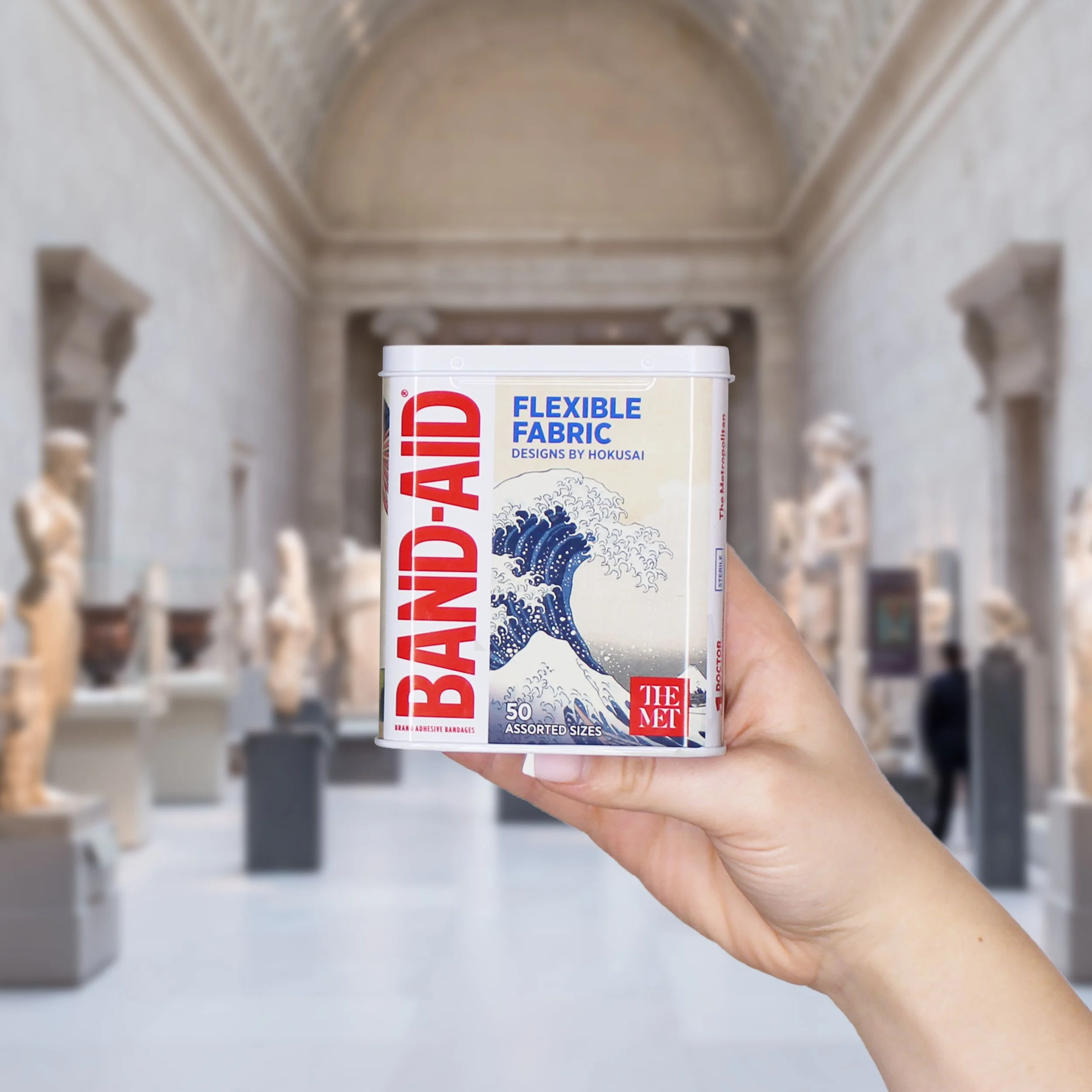 Band-Aid x The Met hand holding tin in the met.jpg