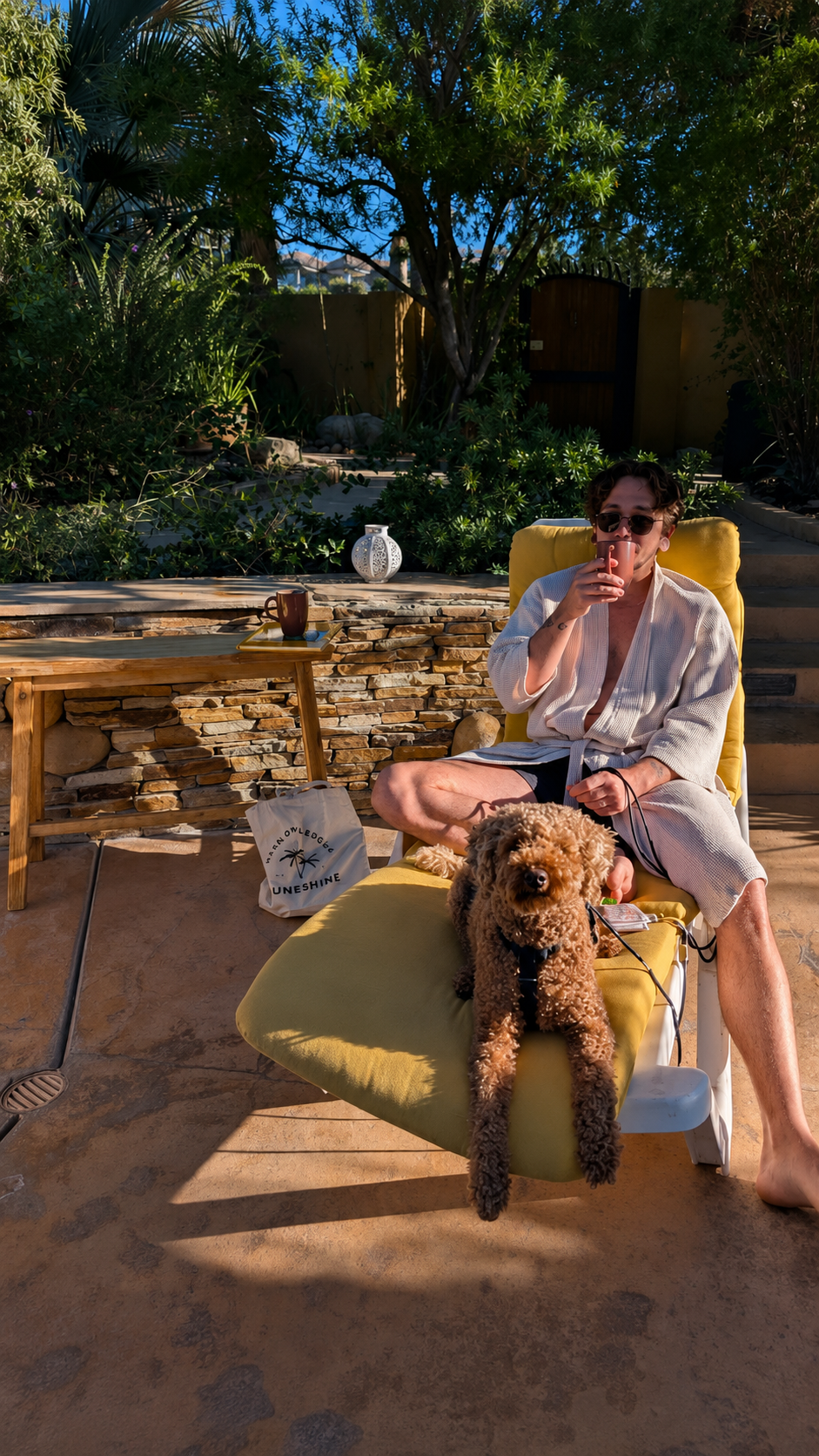 Guest relaxing poolside with their dog at The Good House boutique hotel in Desert Hot Springs.